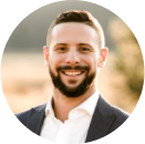A man with a beard, wearing a suit jacket and white shirt, smiling outdoors with a blurred background—reflecting confidence in the fight against financial crime and cybersecurity threats.